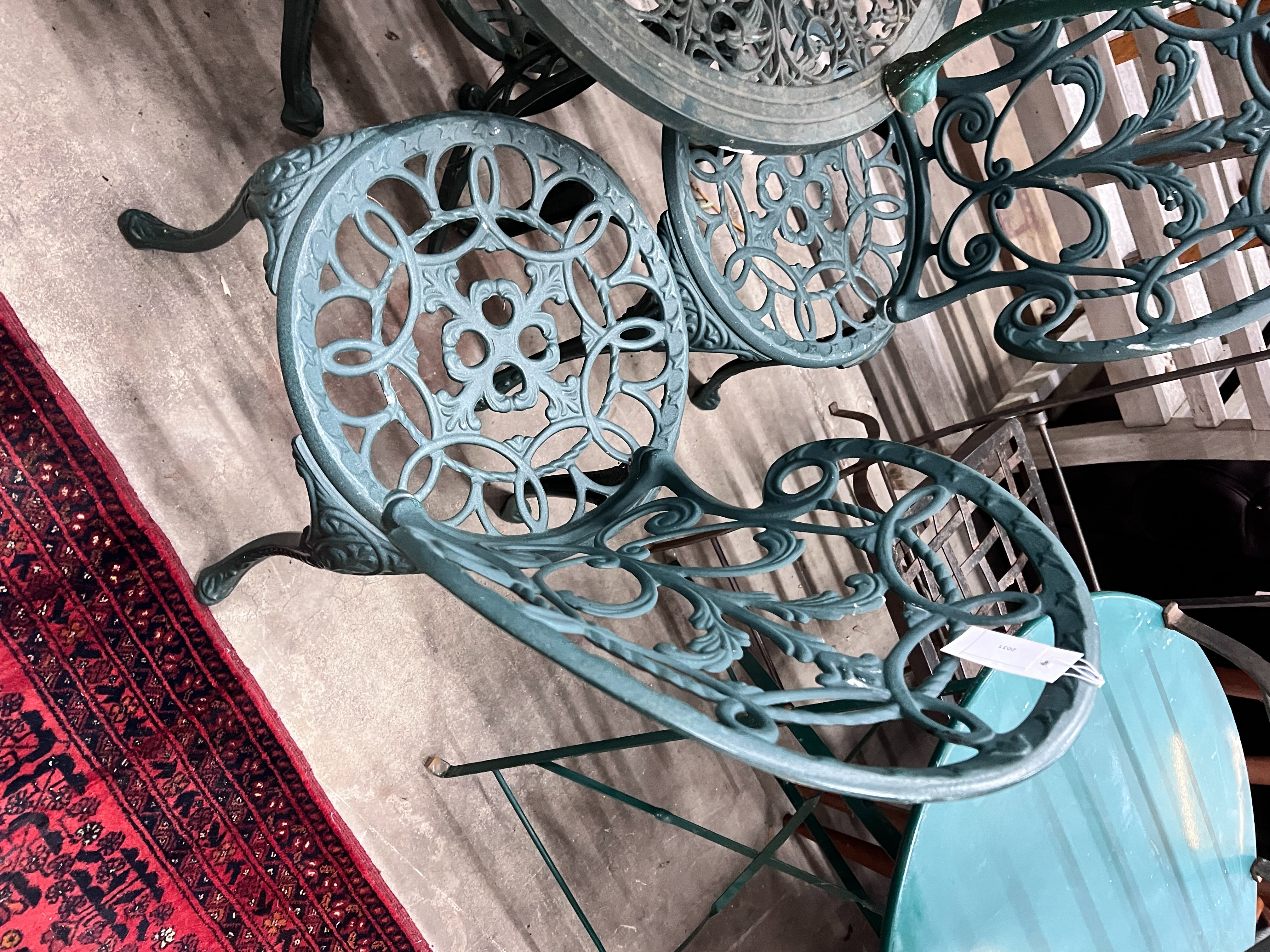 A Victorian style painted aluminium circular garden table, four chairs and a low garden table, larger diameter 60cm, height 63cm